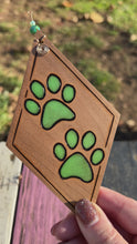 Load and play video in Gallery viewer, Green Paw Prints Ornament